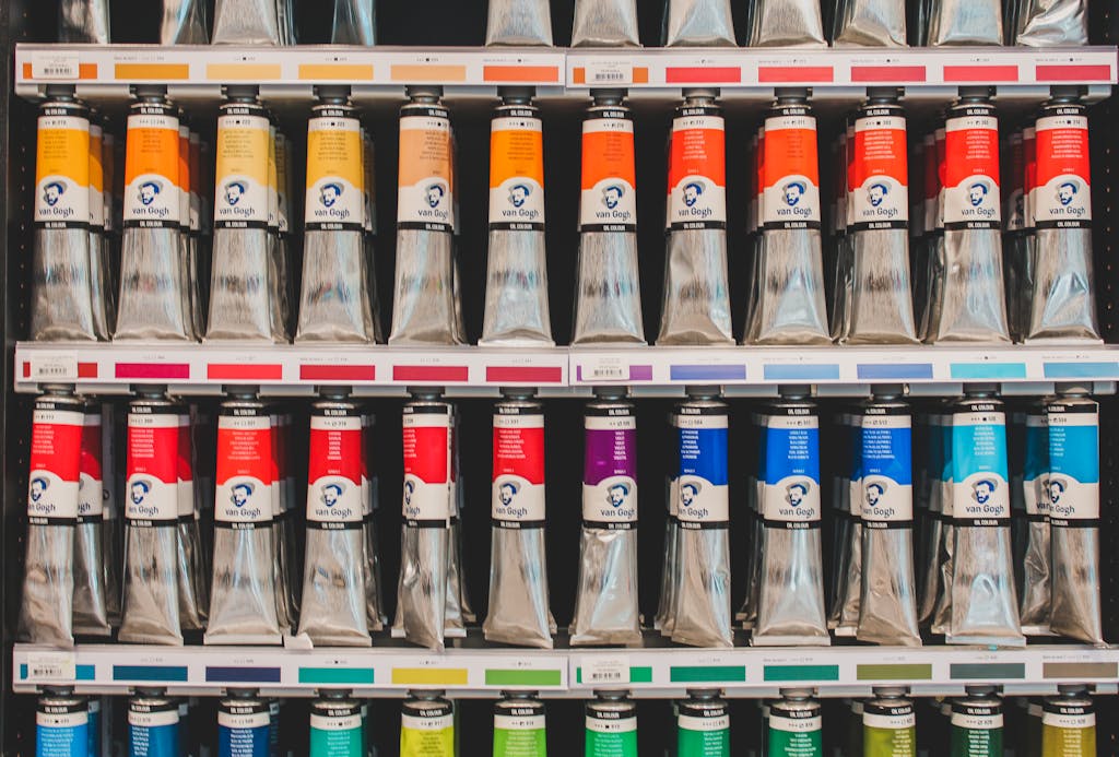 A vibrant selection of Van Gogh oil paint tubes neatly arranged on shelves in a store.